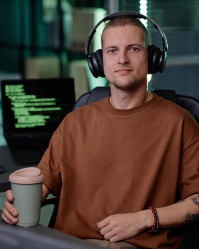 portrait-of-male-it-developer-in-headphones-sittin-2025-03-10-03-27-12-utc-e1742456314885.jpg